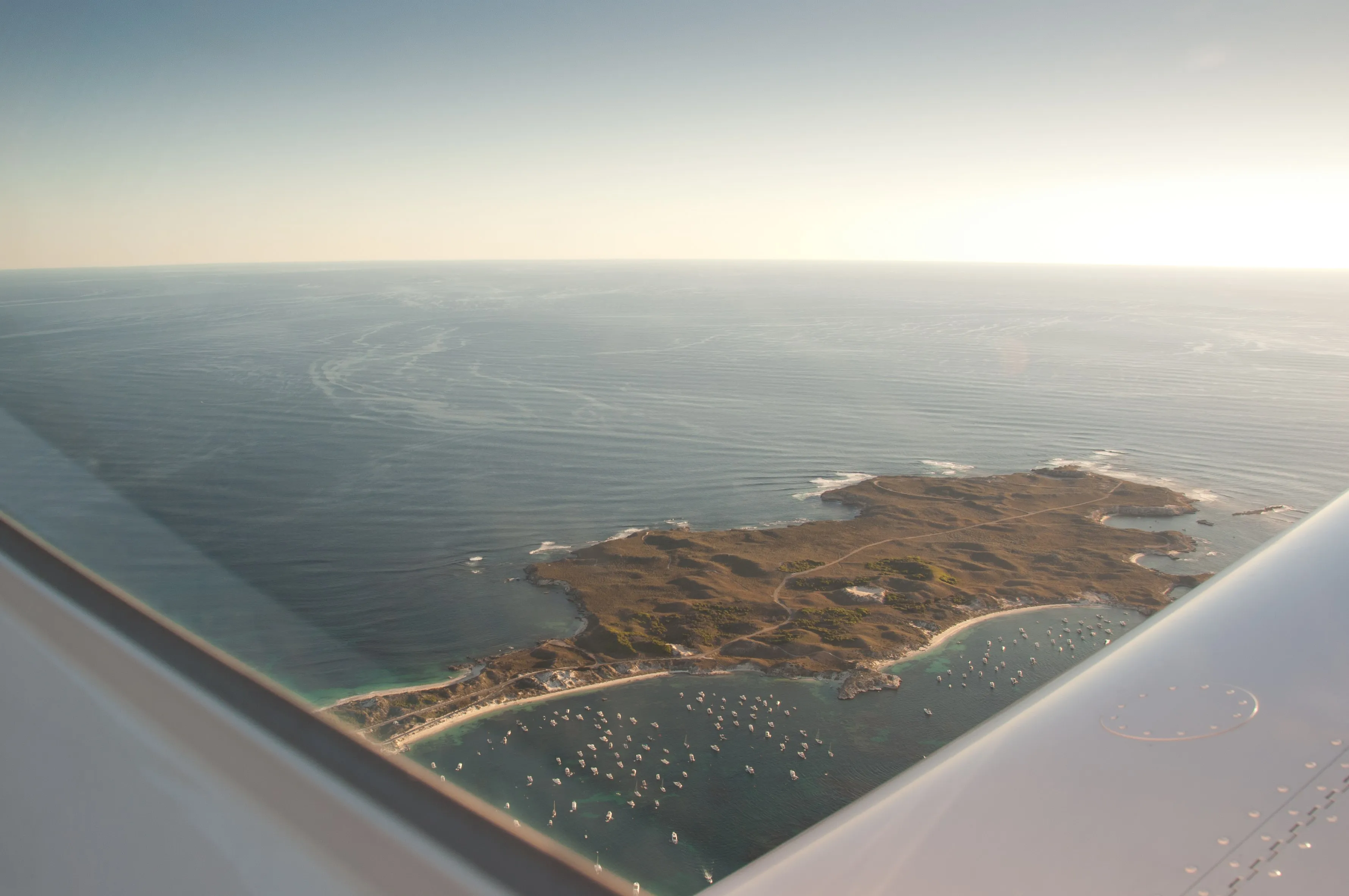 Rottnest Island and moored boats seen from VH-EZT at dusk