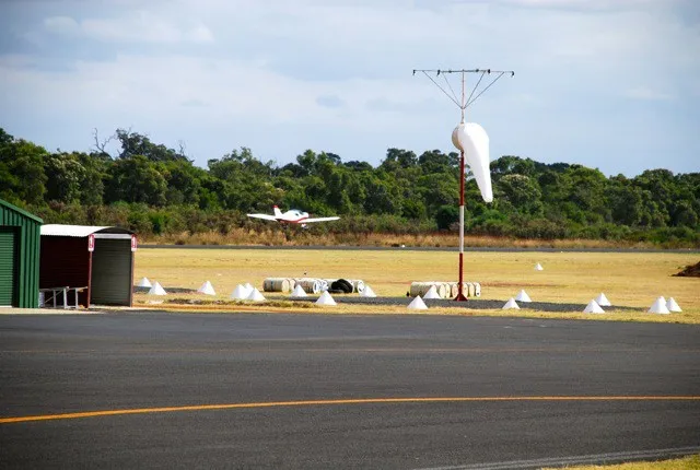 VH-EZT lifting off past the windsock at Bunbury Airport