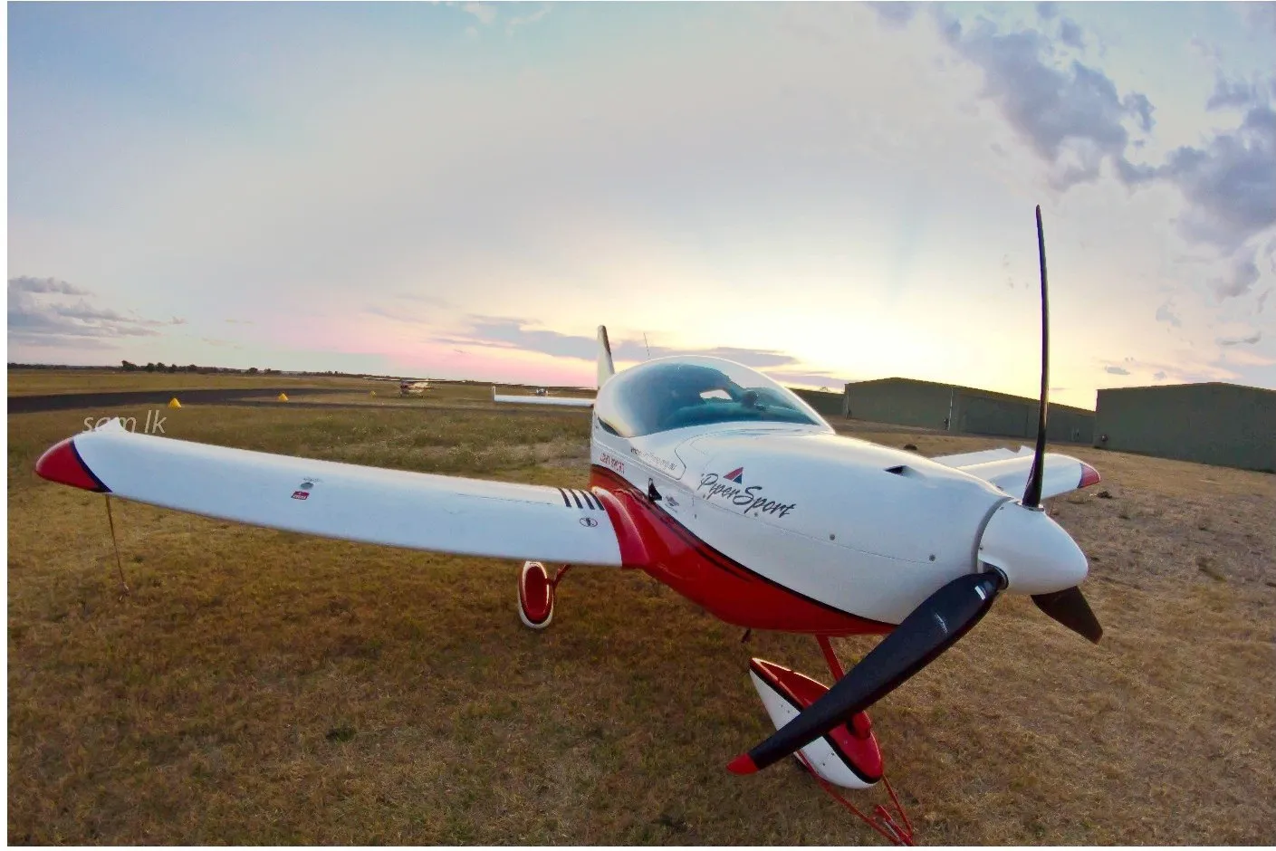 Wide-angle view of VH-EZT at Busselton Airport at dusk
