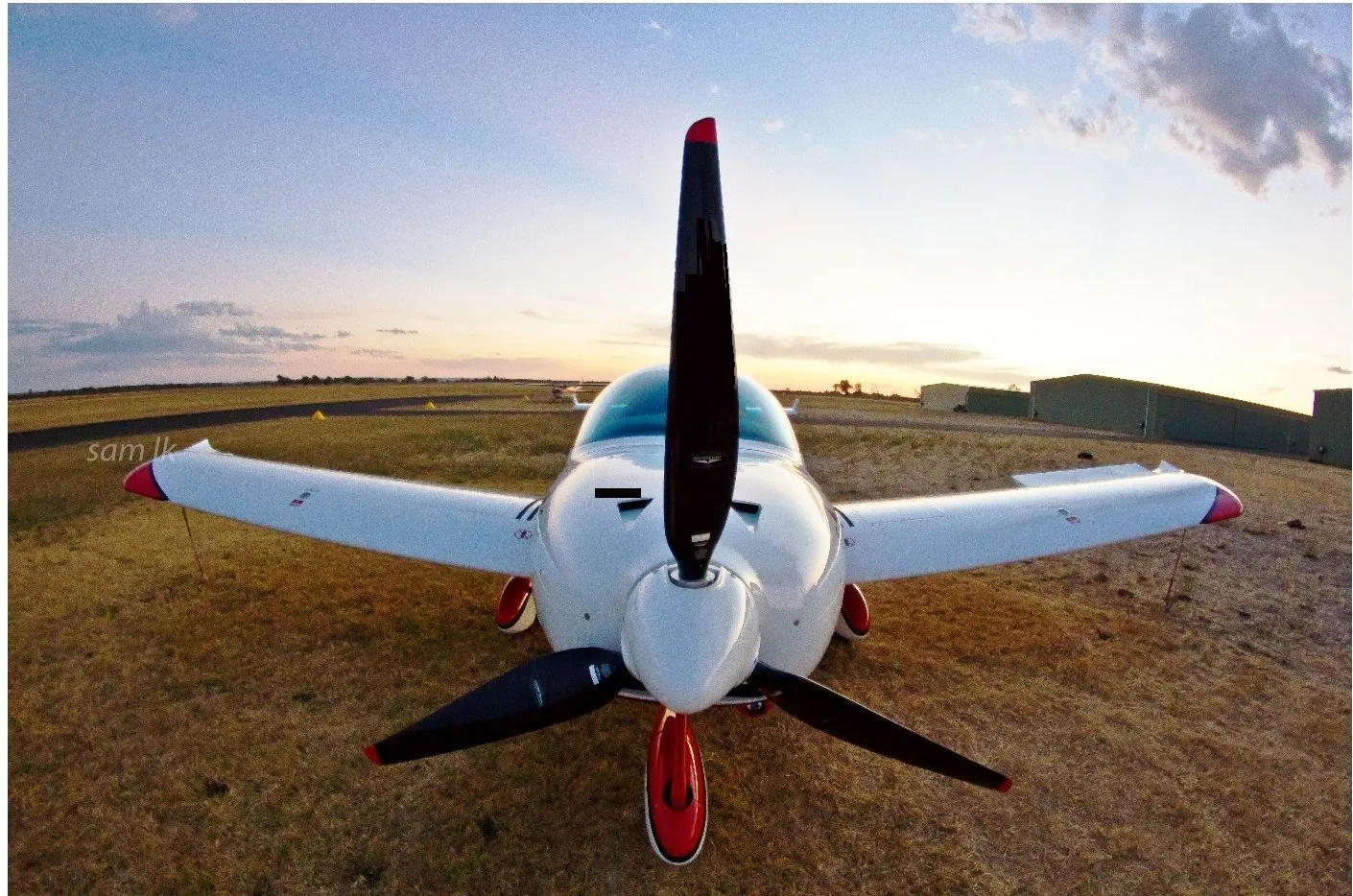 Head-on view of VH-EZT's nose and propeller at dusk at Busselton Airport