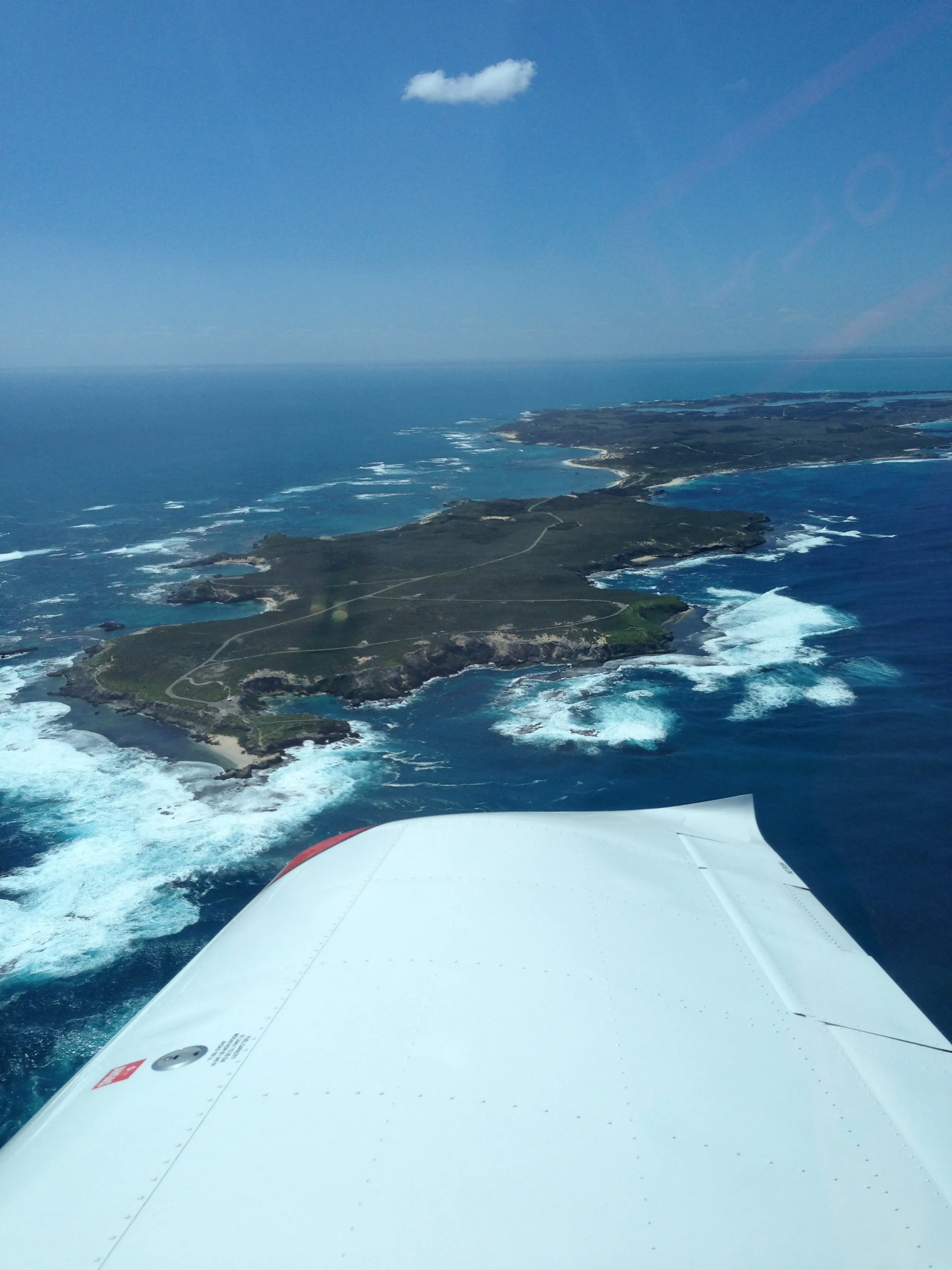 The western end of Rottnest Island seen over VH-EZT's wing