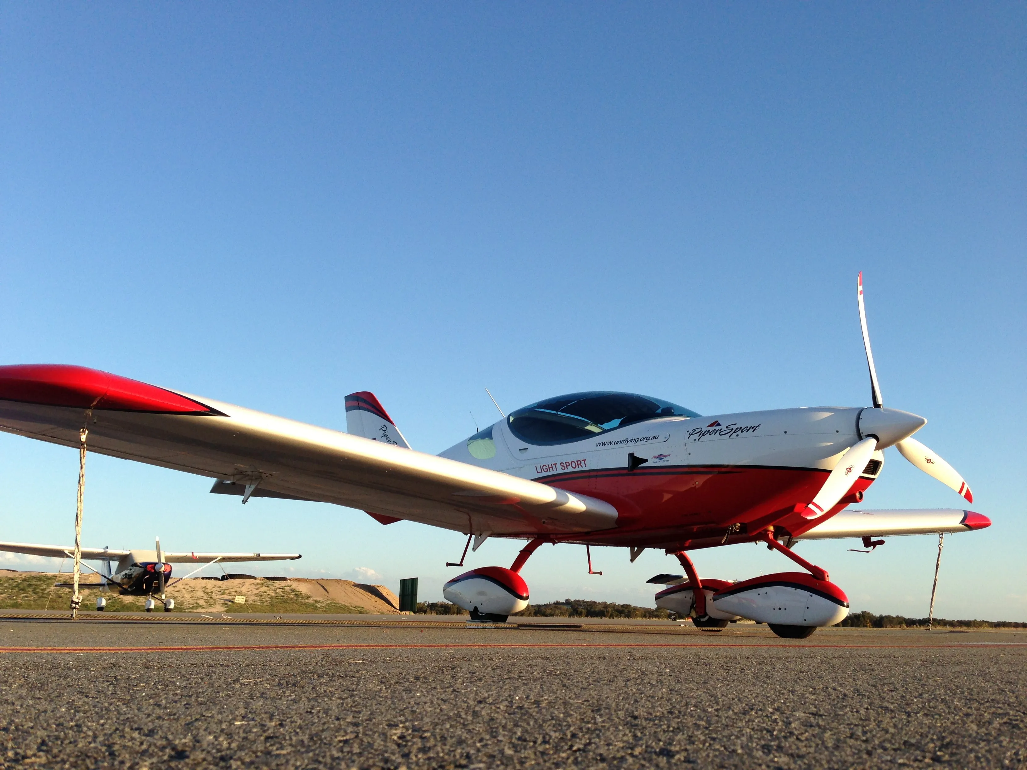 VH-EZT tied down at Jandakot in late-afternoon light