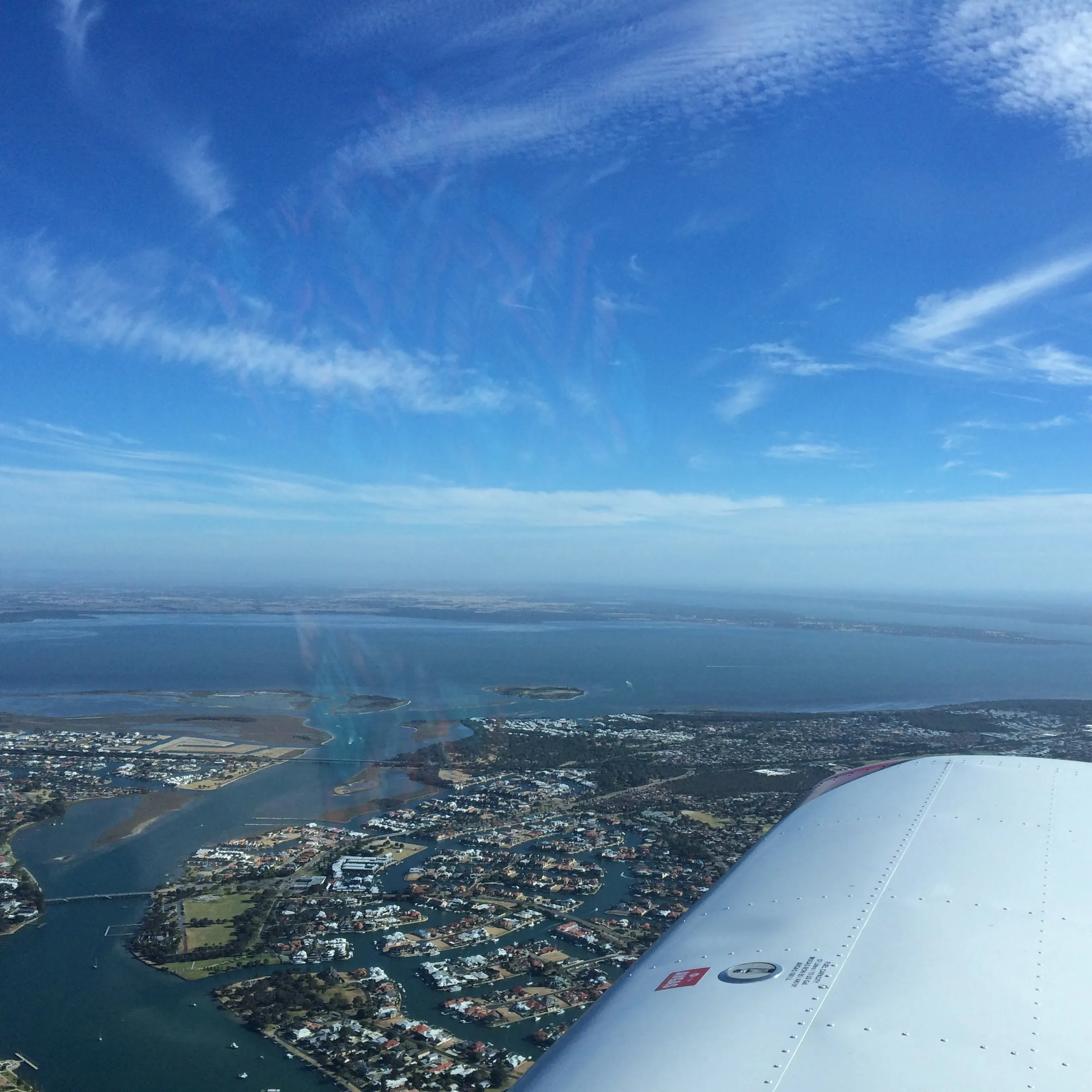 Canal estates and islands in the Peel Estuary at Mandurah, seen from VH-EZT